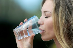 Closeup of blond woman drinking water from glass