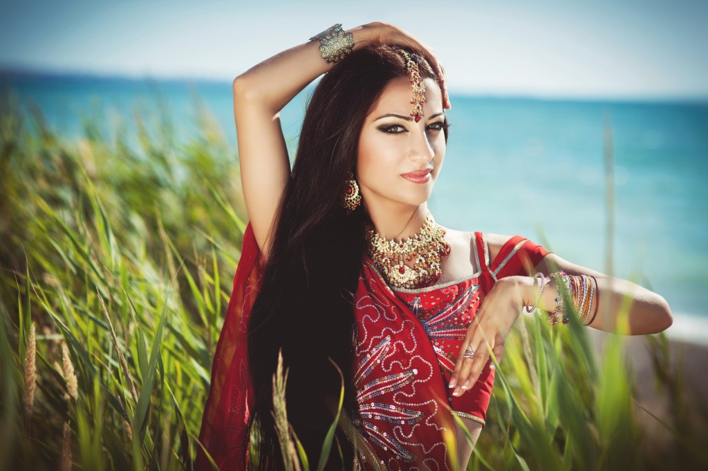 Beautiful indian woman dancing in sari. Arabian bellydancer