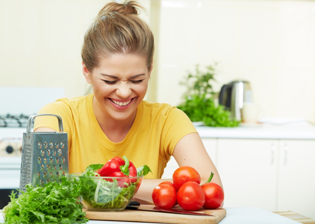 Laughing woman portrait in kitchen.