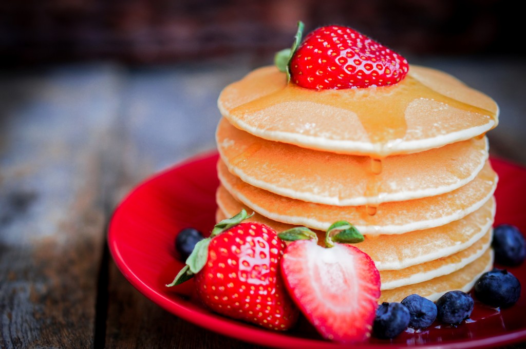 Tasty homemade pancakes with strawberries,blueberries and maple