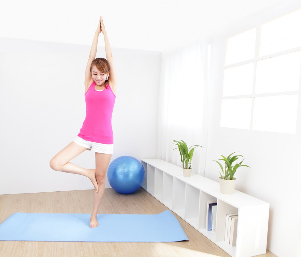 healthy young woman doing yoga at home