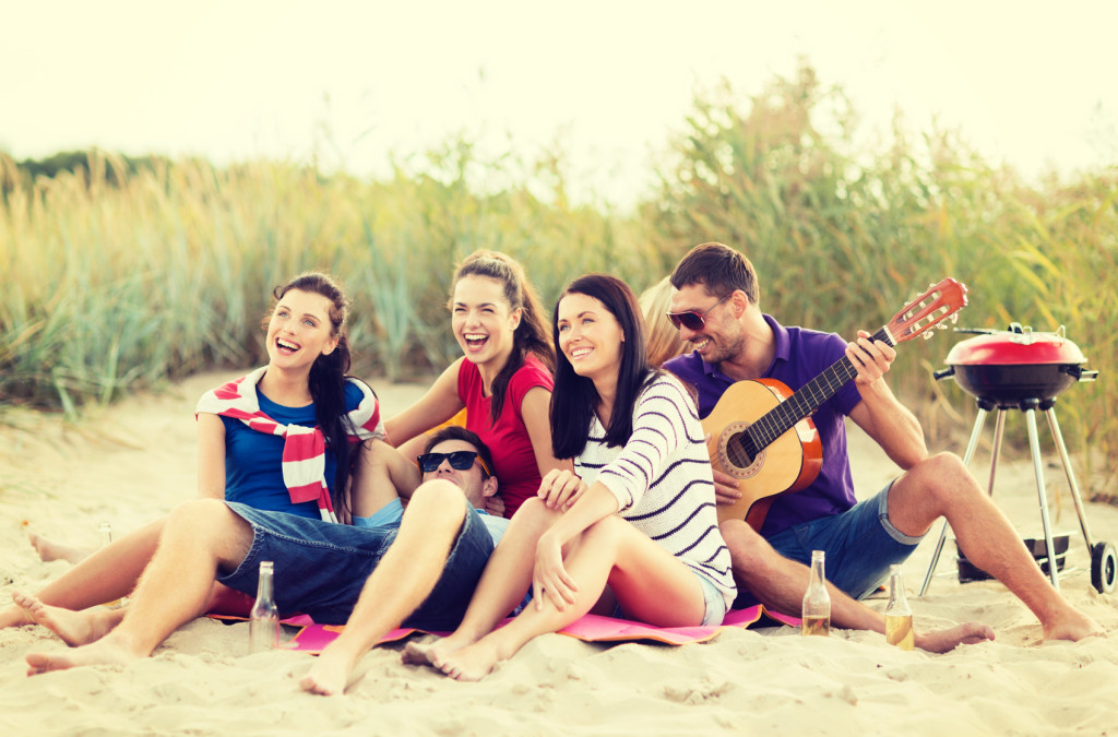 group of friends having fun on the beach