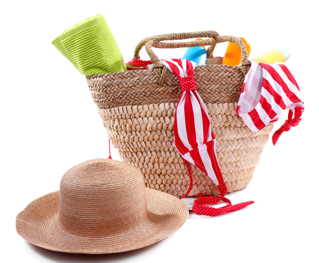 Wicker bag and swimsuit, isolated on white