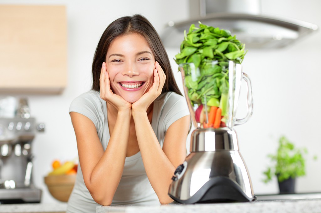 Green smoothie woman making vegetable smoothies