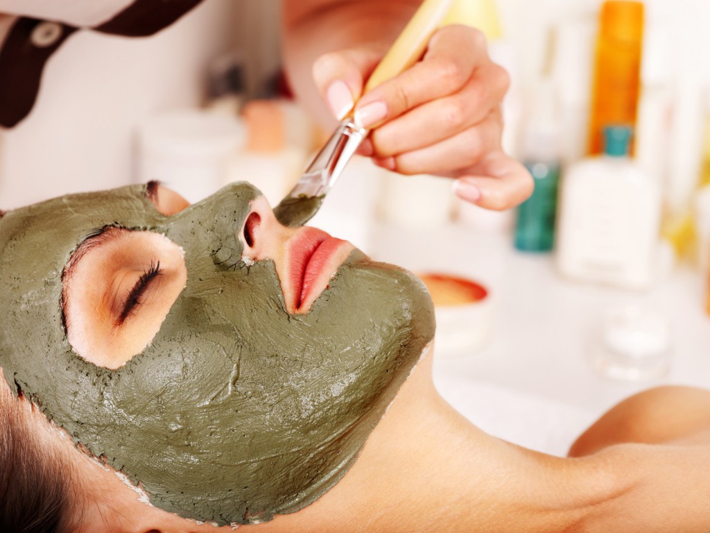 Clay facial mask in beauty spa.