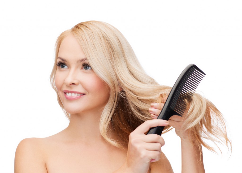 smiling woman with hair brush