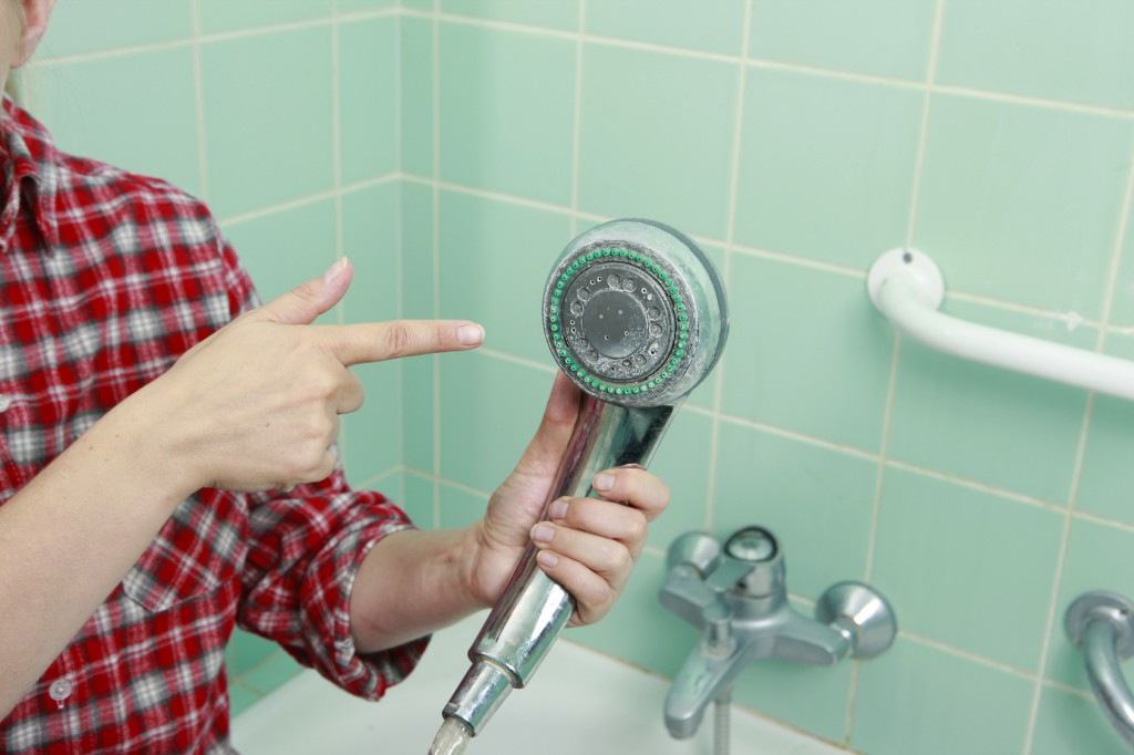 woman cleaning an old dirty bathroom