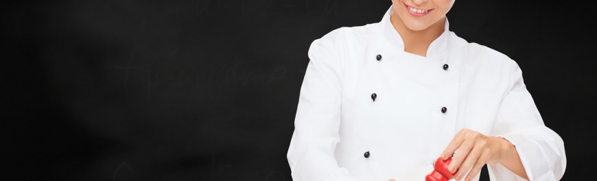 smiling female chef with preparing salad