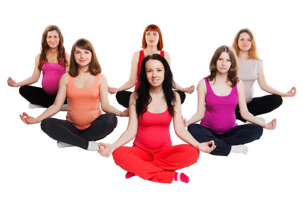 group of six pregnant women doing yoga