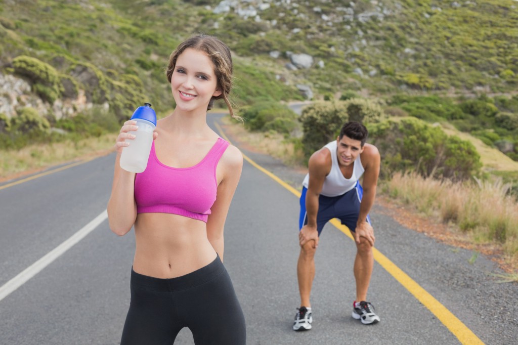 Portrait of a fit couple standing on road
