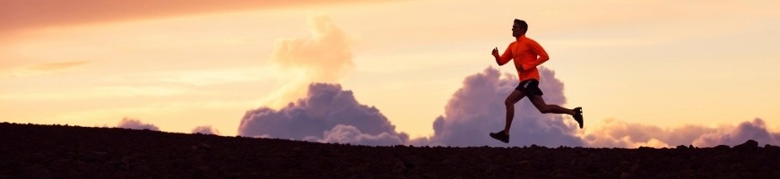 Male runner silhouette, running into sunset